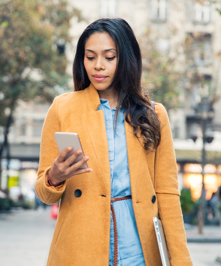 Woman looking at her phone contemplating mobile security.